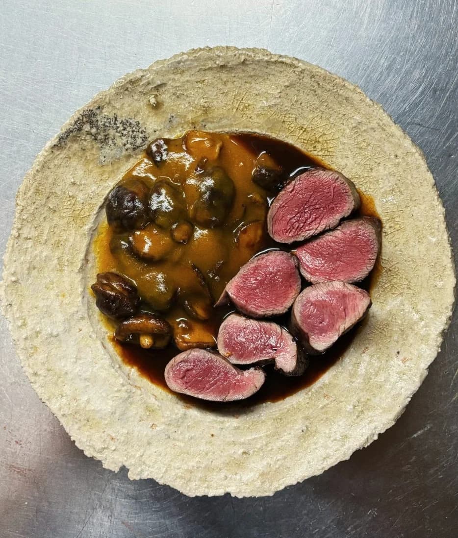 Duck and fig dish plated for restaurant service