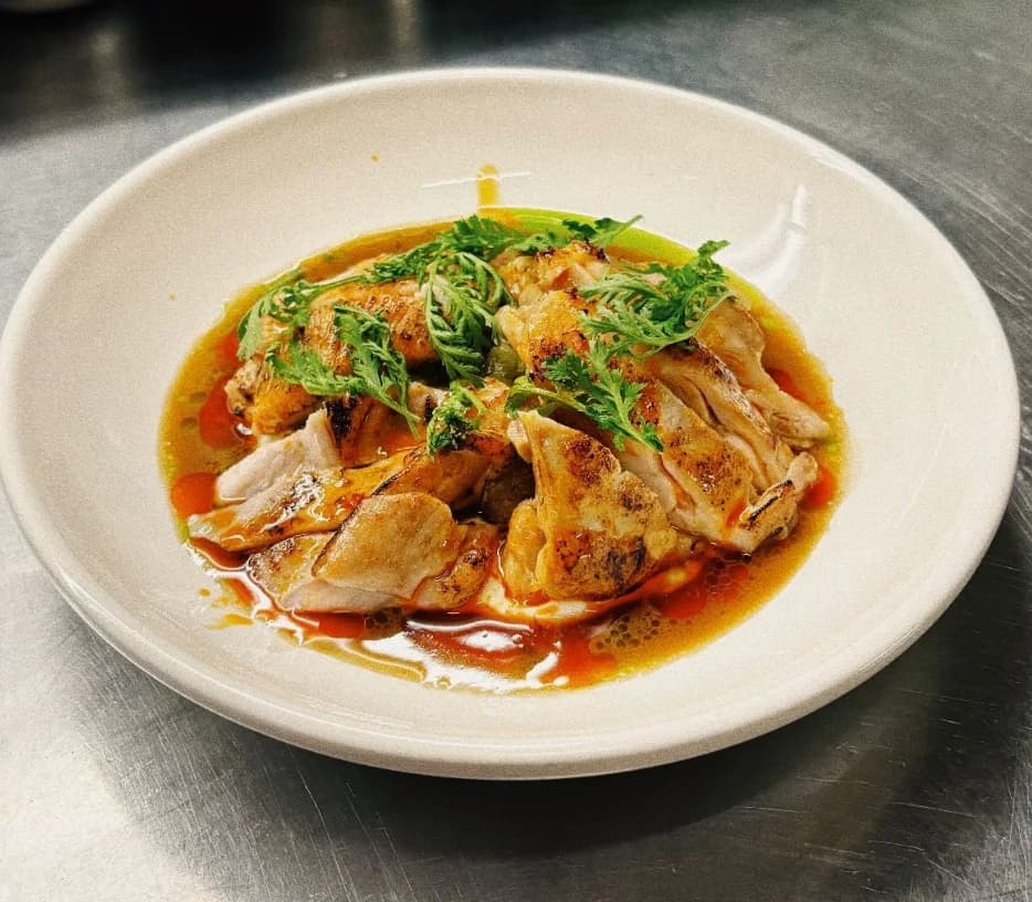 Finished dumplings served in a clear aromatic broth