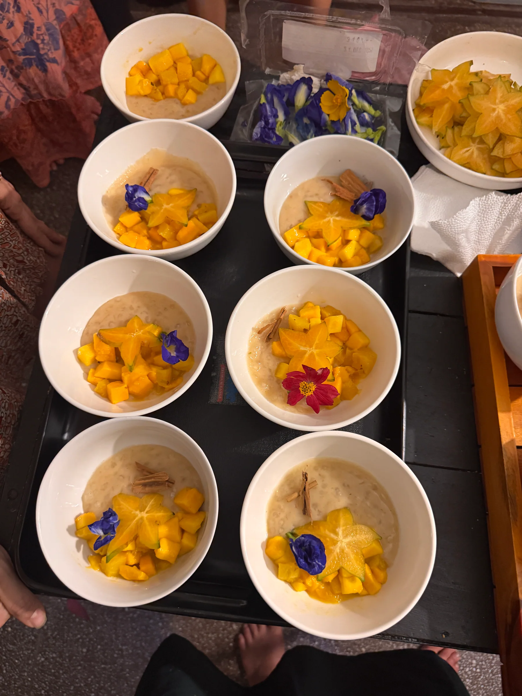 Finished tropical fruit dessert with edible flowers